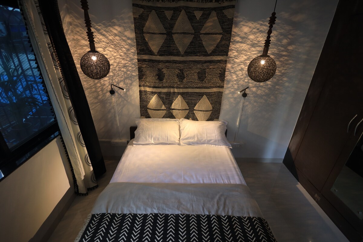 Afrohemian House bedroom layered with bohemian textiles