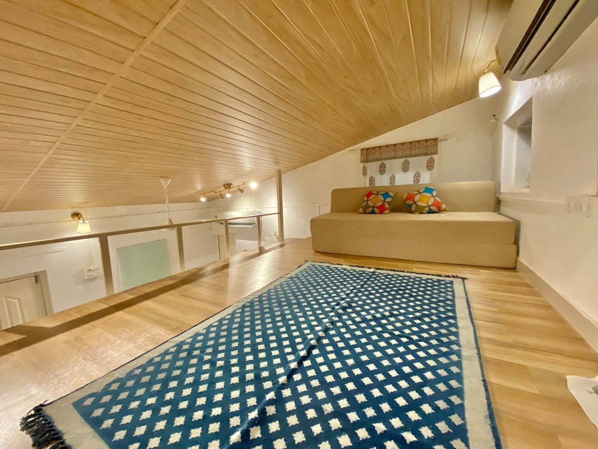 Bandra Cottage bedroom loft overlooking the yard