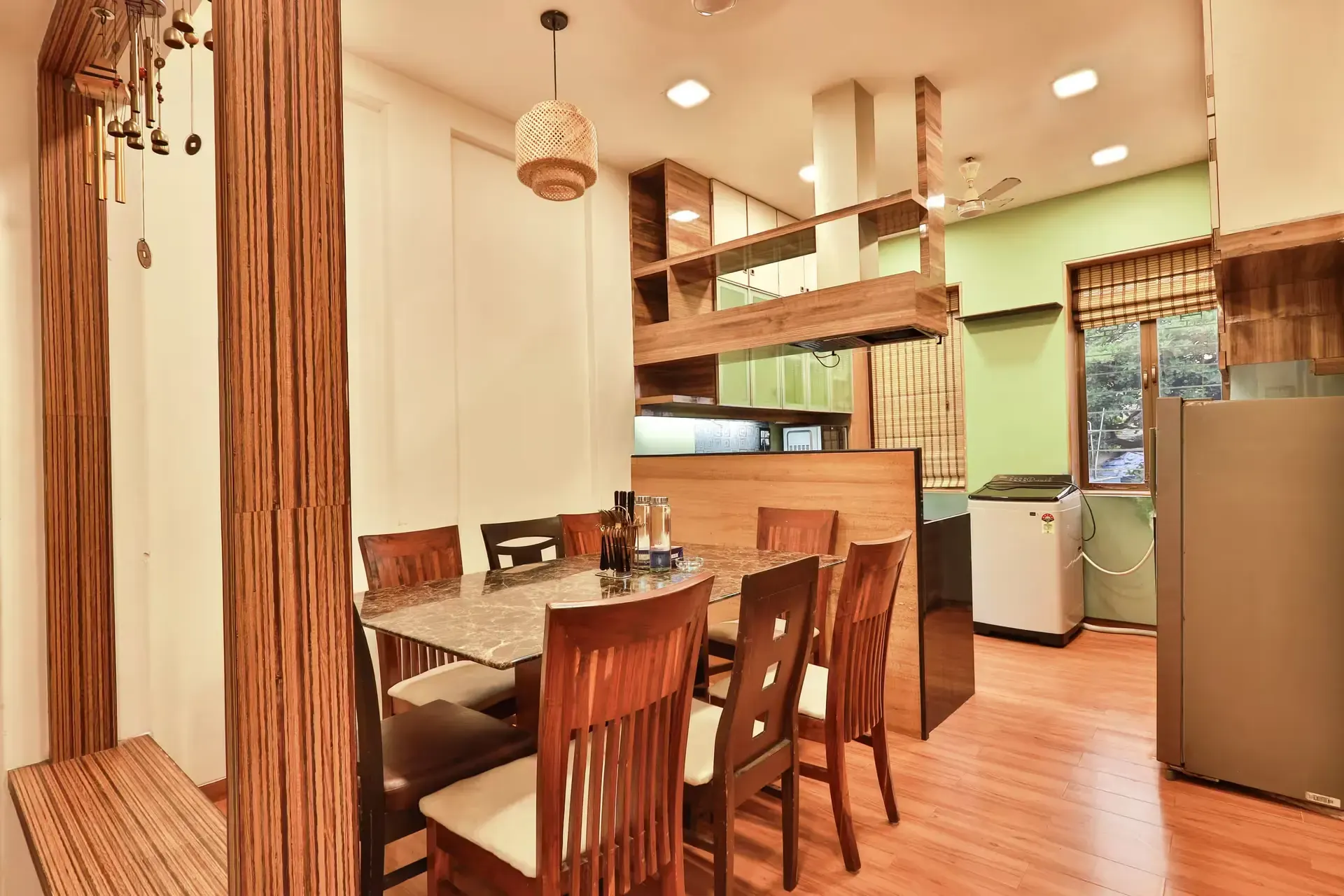 Dining area with a wooden table and chairs beside the kitchen