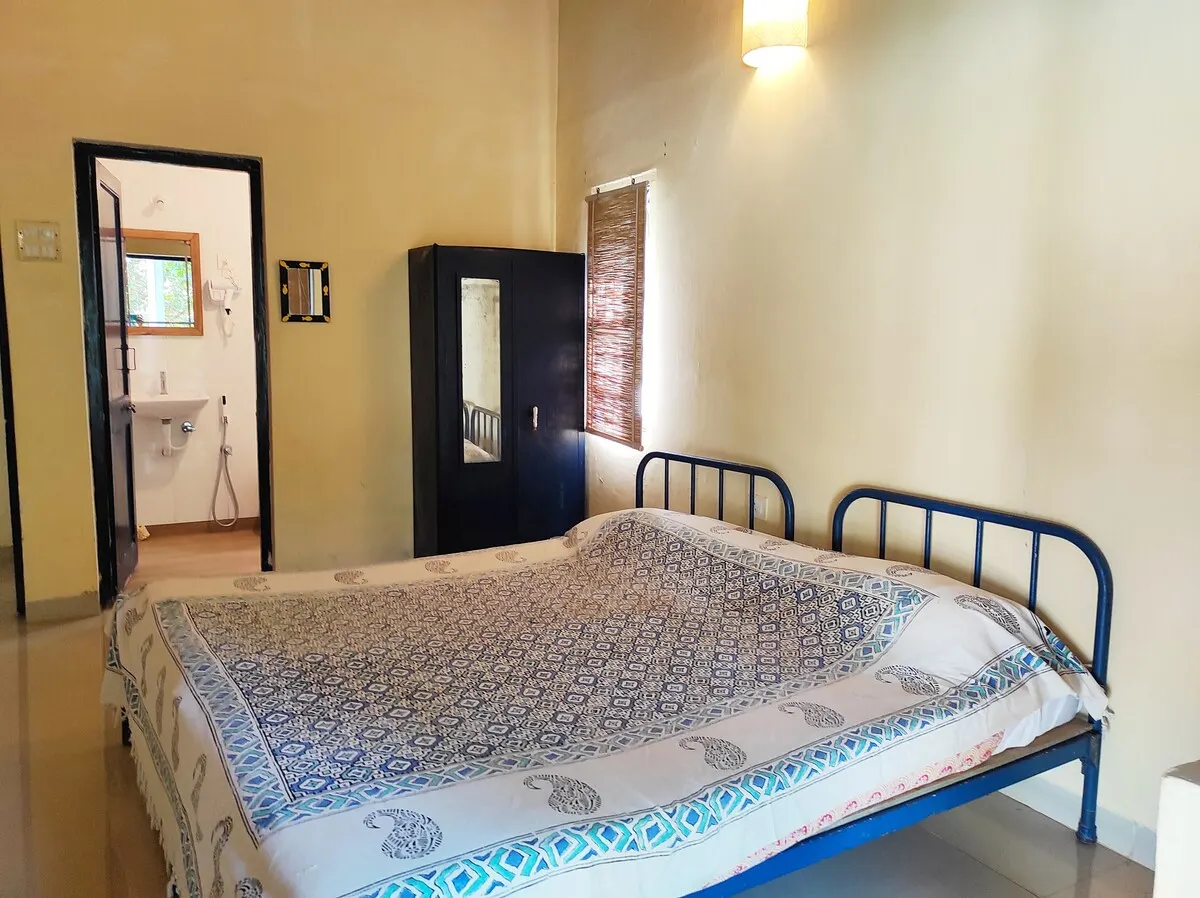Kashid Cottage bedroom with an ensuite bathroom