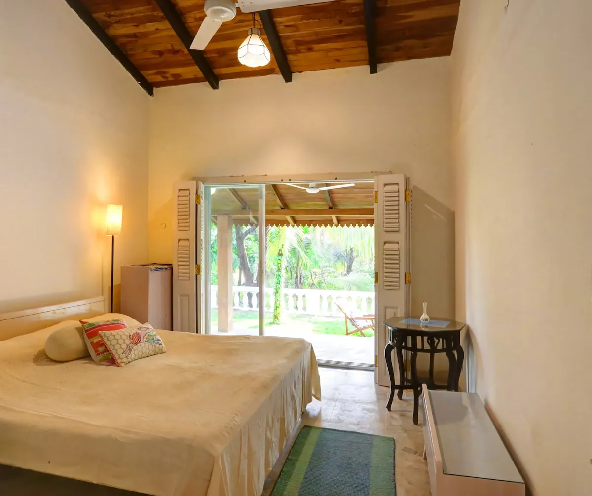A La Mer bedroom opening onto the veranda and garden
