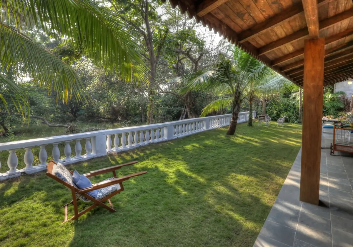 La Mer's private lawn and stone balustrade bordering the wildlife sanctuary treeline