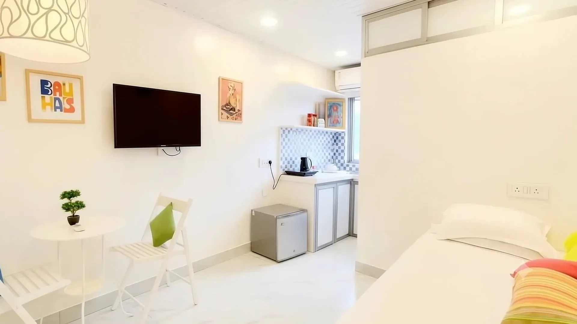 The white shell and colourful cushions of Little Bandra Studio